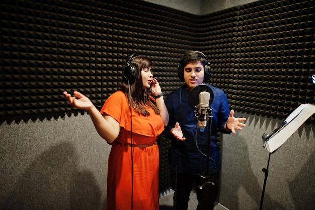 Student practicing singing fundamentals with guidance from experienced music coach