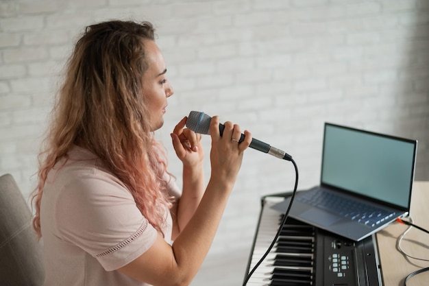Voice coach conducting one-on-one vocal instruction focusing on pitch accuracy and tone development