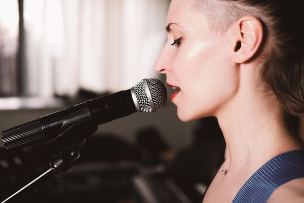 Professional vocal training instructor demonstrating singing techniques during voice lessons