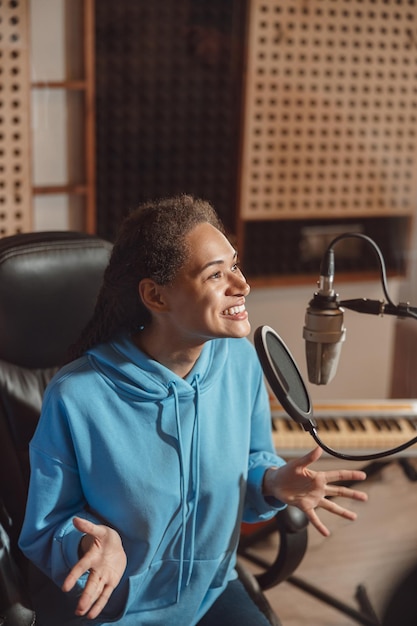 Recording studio session capturing vocal performance during professional singing instruction and audio production
